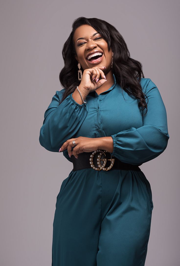 Dr. Ashanti Odom laughing in a teal ensemble